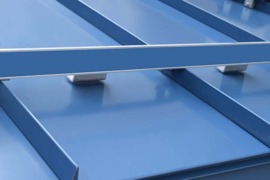 ColorBar snow rail with snap-in color strip and IceStoppers installed on a standing seam metal roof