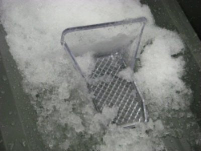 SnoBlox Ace snow guards holding snow on a metal roof