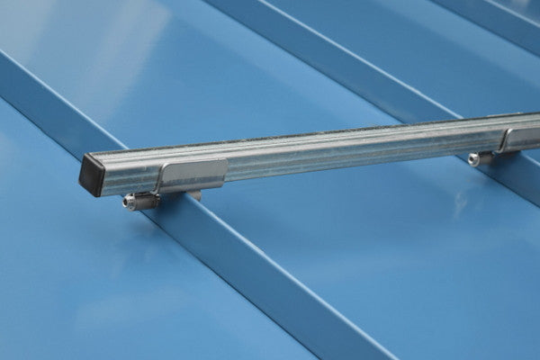 SnoBar snow rail clamped to a standing seam metal roof